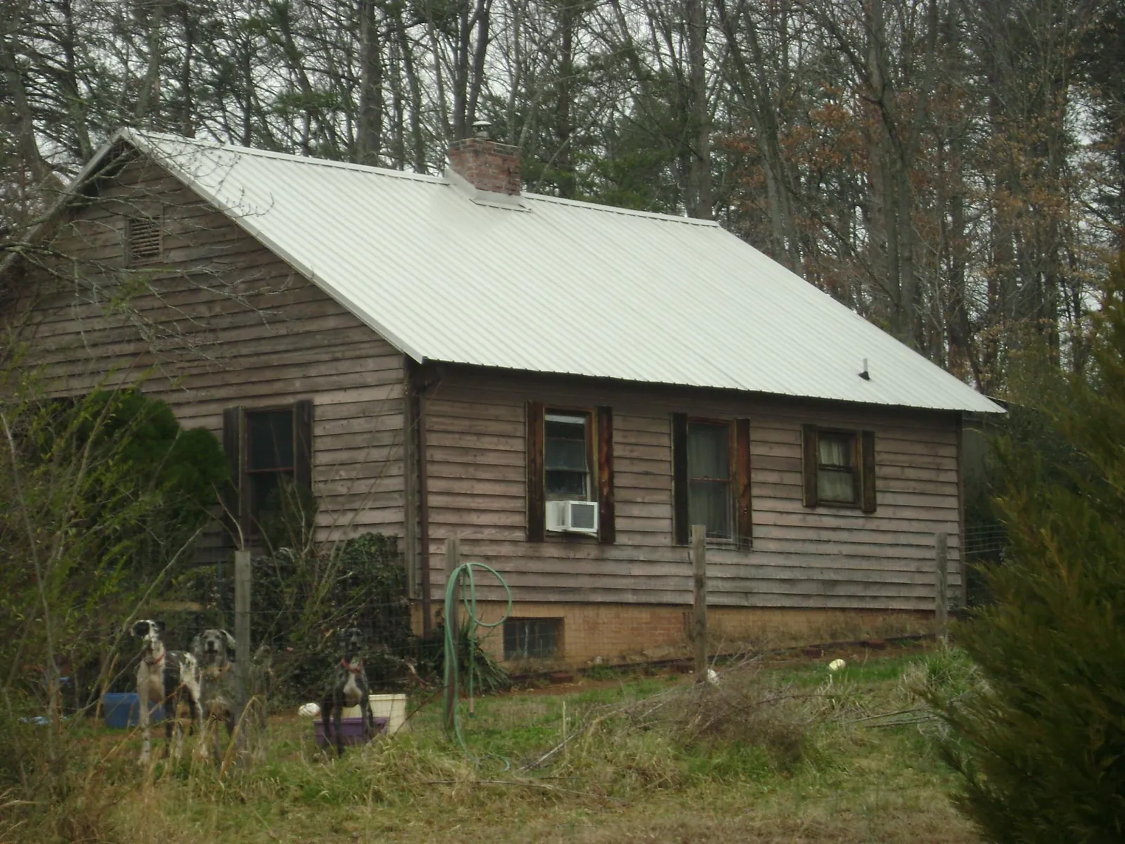 White metal roof on an old wood sided farmhouse, from a Asphalt Shingle Roof Repair job in Kinsale